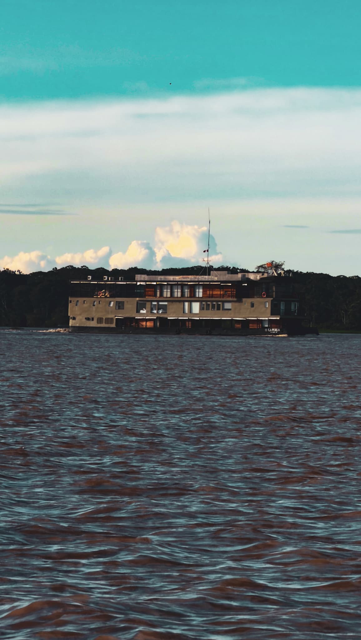 A riverboat on the Amazon beneath a blue sky